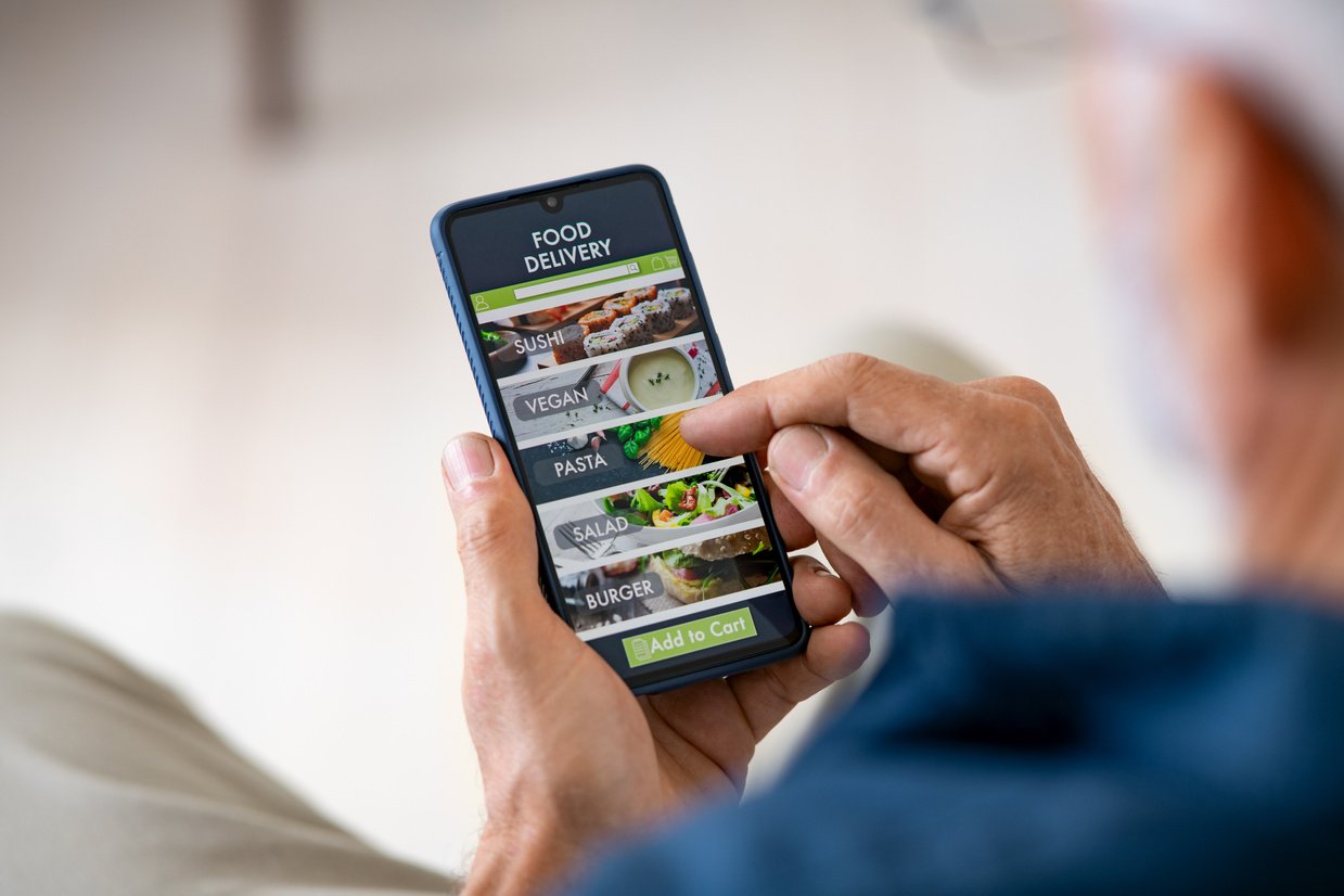 Man Using Mobile App to Order Delivery Food