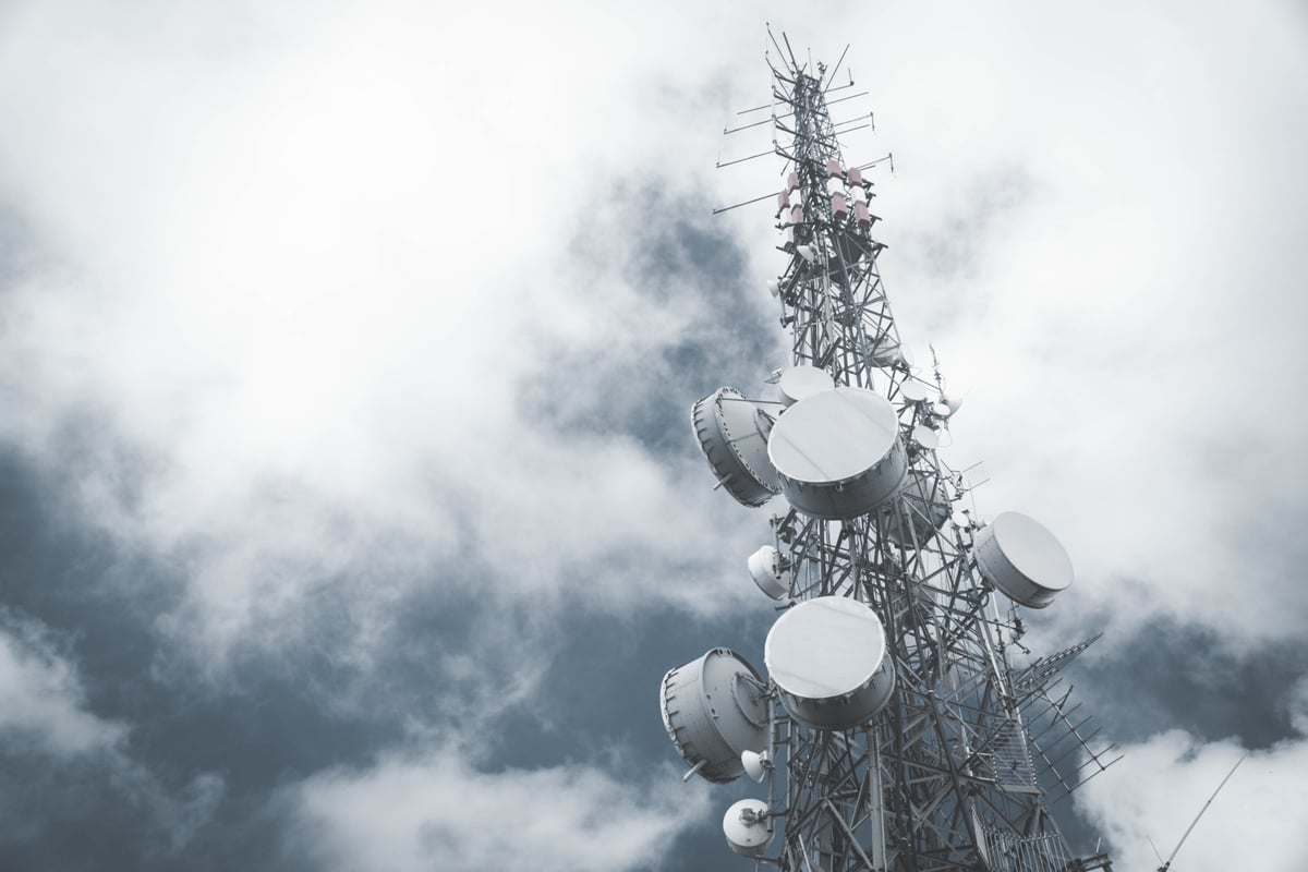 White and Red Satellite Dish Under Cloudy Sky